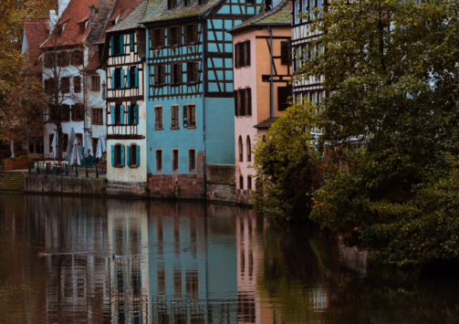 A vertical shot of vintage small houses along the river in the Petite-France region of Strasbourg